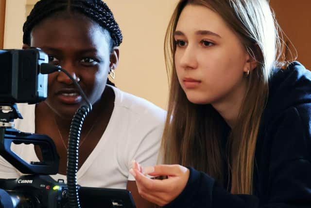 Director Kate Kurdinovych (right) sets up a shot with fellow student Temi Oyeparlola.