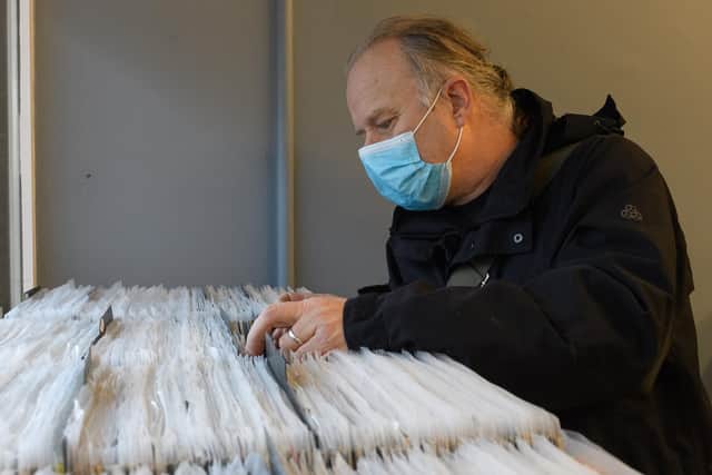 Kevin Ilsley sorts through the records own sale.
Picture: Keith Woodland (121220-20)