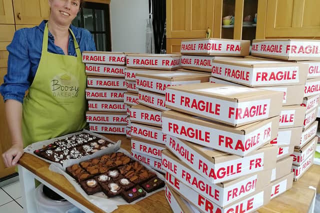 Michelle Wilding, who runs Boozy Bakers from her home in Denmead with some of the packages of cakes the business has sent out nationwide. 