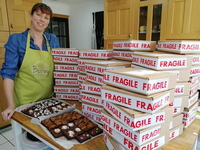 Michelle Wilding, who runs Boozy Bakers from her home in Denmead with some of the packages of cakes the business has sent out nationwide. 