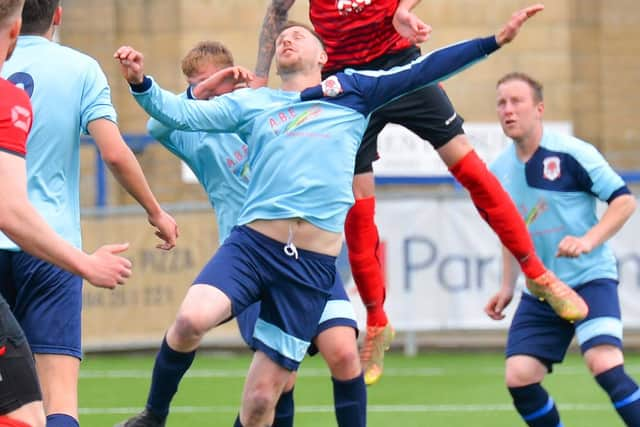 Shane Kent rises high to head Locks Heath into an early lead against Bush Hill. Picture: Martyn White.