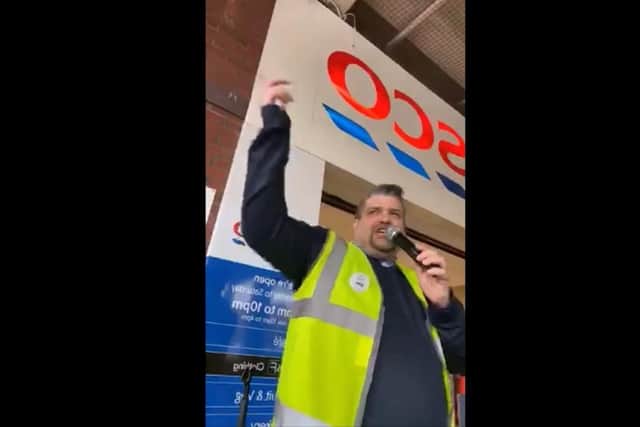 Steve Taylor, cafe manager at Tesco supermarket, singing outside the store.