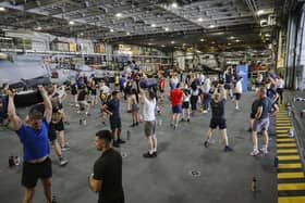 HMS Queen Elizabeth's ship's company take part in circuits in the hangar. Picture: LPhot Belinda Alker.