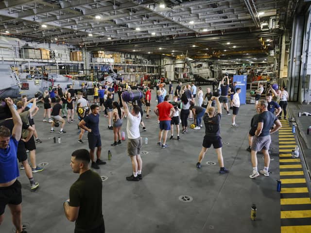 HMS Queen Elizabeth's ship's company take part in circuits in the hangar. Picture: LPhot Belinda Alker.