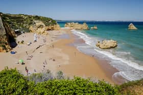 Travel restrictions for UK tourists vary greatly in different countries, including Spain, Portugal, France, Greece, Italy, and Norwar. Dona Ana beach in Lagos on April 18, 2018, in the southern Portugal region of Algarve. Picture: LUDOVIC MARIN/AFP via Getty Images.
