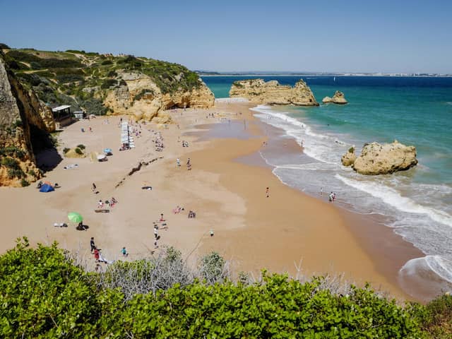 Travel restrictions for UK tourists vary greatly in different countries, including Spain, Portugal, France, Greece, Italy, and Norwar. Dona Ana beach in Lagos on April 18, 2018, in the southern Portugal region of Algarve. Picture: LUDOVIC MARIN/AFP via Getty Images.