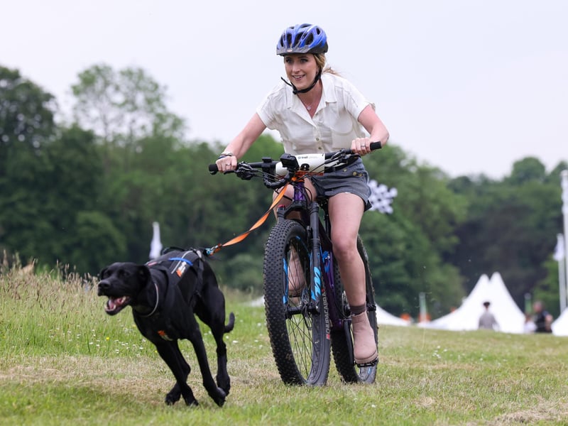 Dame Laura Kenny takes part in CaniBike at Goodwoof 2024, a dog event held at Goodwood Estate in Chichester. PA Photo. This year's event features a Labrador Parade, led by The Duke of Richmond, in celebration of the breed. Elsewhere at the event, visitors can try forest bathing, truffle hunting, watch top canine athletes in competition, enjoy wellness workshops and listen to talks from behavioural and veterinary experts. Picture credit should read: Matt Alexander/PA Media