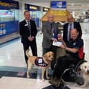 Allen Parton from Hounds for Heroes and his assistance dogs accepting the donation from The Rotary Club of Fareham.