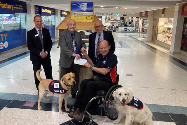 Allen Parton from Hounds for Heroes and his assistance dogs accepting the donation from The Rotary Club of Fareham.