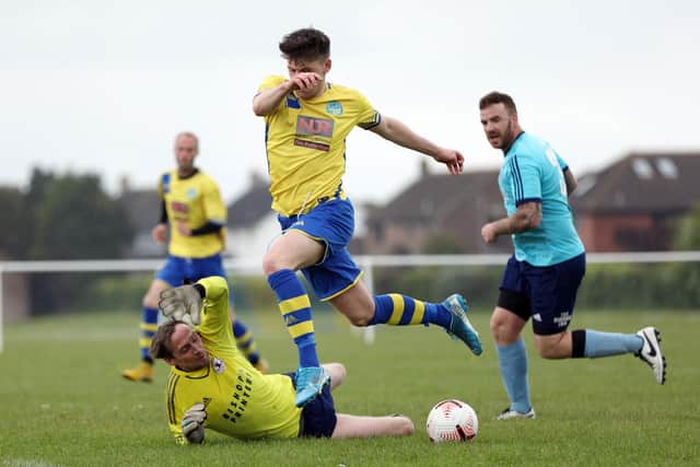 Portchester Rovers manager Chris Yoxall, playing as stand-in keeper, tries to stop Bayley Whitcombe from scoring. Picture: Chris Moorhouse
