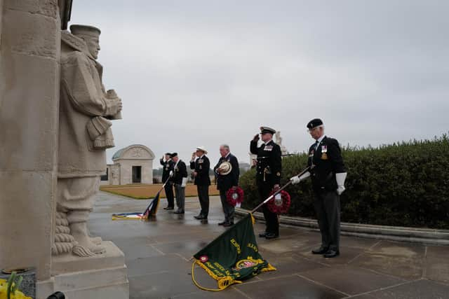 Warrant Officer Mick Turnbull taking the salute supported by Vice Admiral John McAnally and Captain Bill Oliphant.