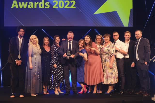 The GFM team collecting the award. Stuart Parker-Tyreman is holding the trophy. On the far left is celebrity host, comedian Richard Ayoade, and on the far right is Jon Severs.