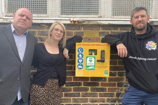Rachel and Andy Morrison from Stag Security and Ray Ogilvie from Friends Fighting Cancer at a defibrillator installed at King George V playing fields in Cosham.