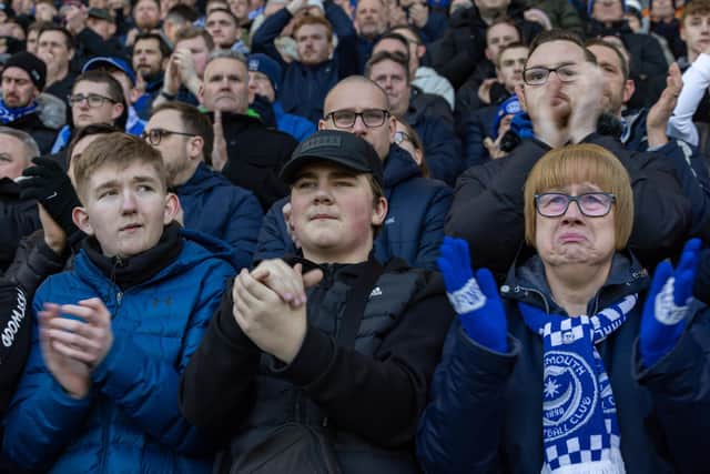 Fans join in with a tribute to Ace Rewcastle during the 8th minute at Fratton Park. Picture: Mike Cooter (210123)