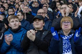 Fans join in with a tribute to Ace Rewcastle during the 8th minute at Fratton Park. Picture: Mike Cooter (210123)