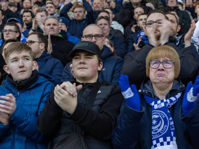 Fans join in with a tribute to Ace Rewcastle during the 8th minute at Fratton Park. Picture: Mike Cooter (210123)