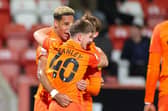 Goalscorer Haji Mnoga is hugged by his Pompey born-and-bred team-mates Alfie Stanley and Charlie Bell. Picture: Nigel Keene/ProSportsImages