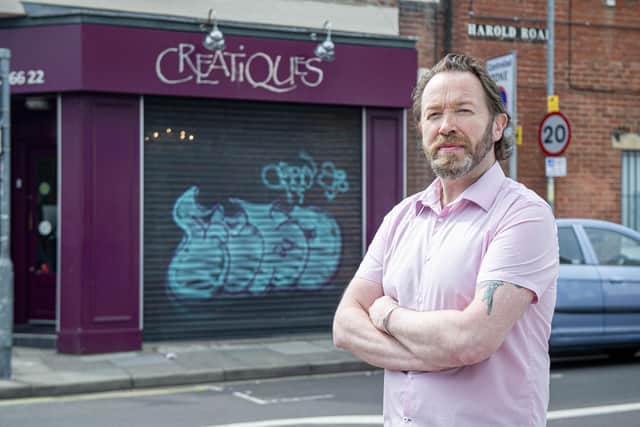 Creative director Rob Pearce outside Creatiques bridal boutique, Southsea with the graffiti on the shutters of his shop. Picture: Habibur Rahman