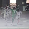 A misty finish at Westleigh Park last night as Josh Passley is mobbed by team-mates after his injury-time leveller against Bath. Picture by Dave Haines.