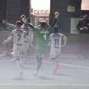 A misty finish at Westleigh Park last night as Josh Passley is mobbed by team-mates after his injury-time leveller against Bath. Picture by Dave Haines.