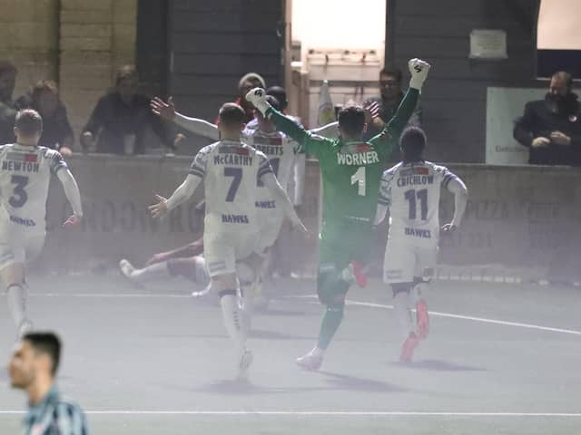 A misty finish at Westleigh Park last night as Josh Passley is mobbed by team-mates after his injury-time leveller against Bath. Picture by Dave Haines.