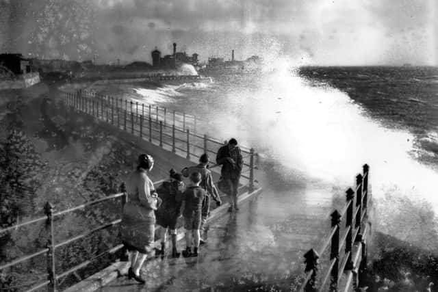November 1938:  People watching big seas breaking over Portsmouth's sea defences.  Picture: Getty