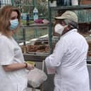 A nurse buys food to a street seller with protective mask outside the hospital of Ahepa in Thessaloniki. Picture: SAKIS MITROLIDIS/AFP via Getty Images