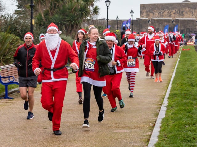 Runners undeterred by the weather start the Santa Fun Run at Southsea Castle