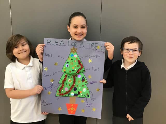 Oliver Jackson, 9, Briana Bildea, 10, and Alfie Valentine, 9, with their Plea for a Tree poster.