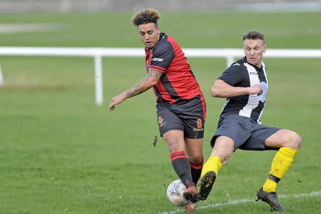 Joel Jackson (red/black) struck a sublime goal for Fleetlands in their draw at Overton. Picture: Ian Hargreaves