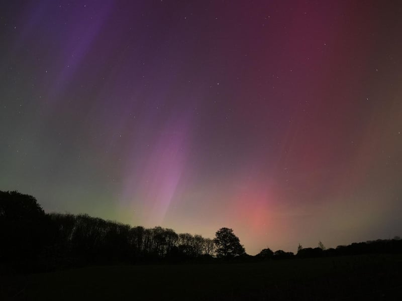 The aurora borealis, also known as the northern lights, glow on the horizon over Basingstoke in Hampshire.