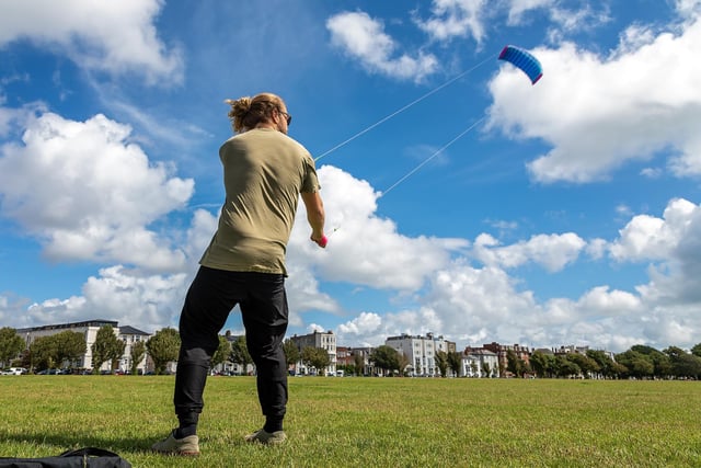 Josh Gent (27) doing his best to not take off at the Portsmouth Kite Festival. Picture: Mike Cooter (070821)