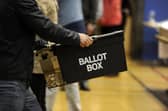Ballot boxes are carried in for counting