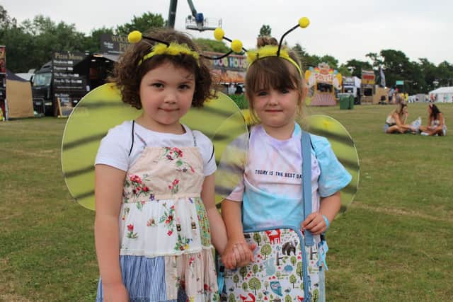 Alana and Ophelia, both aged four and from the Isle of Wight. They are both excited to ride on the ferris wheel.