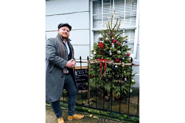 Lewis Mason next to the community Christmas tree he put up in Castle Road