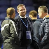 Richard Hughes (centre) was at a Pompey match for the first time on Tuesday night following his arrival as sporting director. Picture: Jason Brown/ProSportsImages