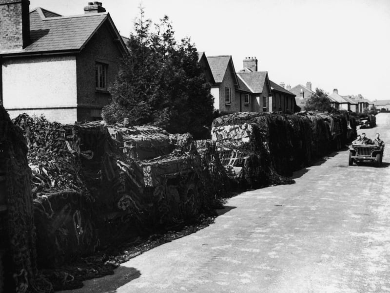 American Army vehicles disguised with camouflage netting, parked along a Hampshire road in, June 1944. (Photo by Keystone/Hulton Archive/Getty Images)