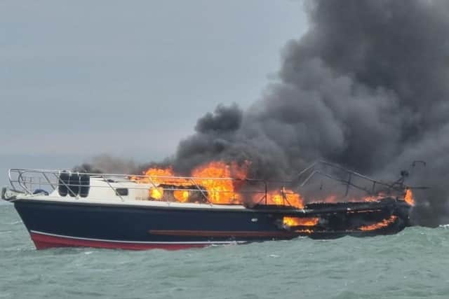Two people were rescued off a burning boat in Portsmouth harbour on June 19. Pic GAFIRS