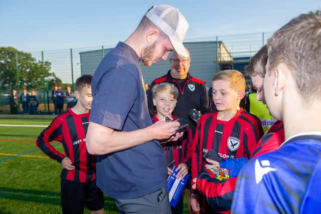 George Hirst signs shirts and shoes on the new pitch
Picture Habibur Rahman