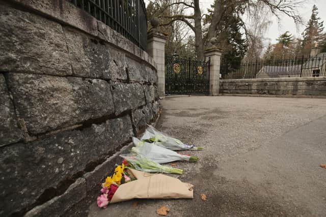 Floral tributes outside the gates at Balmoral Castle. Picture: Jane Barlow/PA Wire