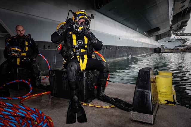 Royal Navy Divers are carrying out work on the hull of HMS Prince of Wales whilst the ship is alonside in HMNB Portsmouth