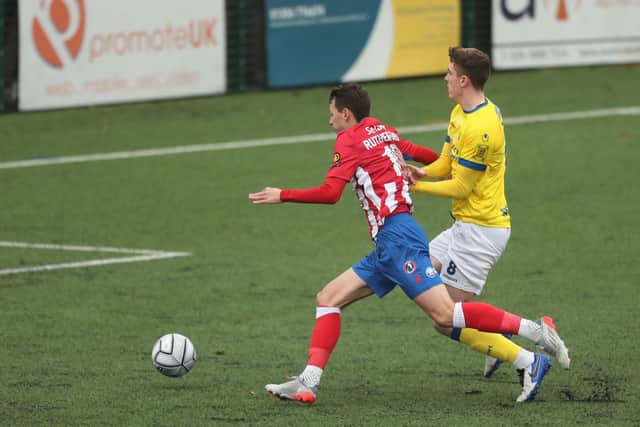 Dorking's Alfie Rutherford is pushed by  Paul Rooney, who is promptly sent off in only the sixth minute.
Picture: Dave Haines