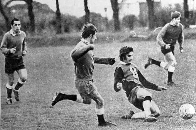 Fred Smith watches Norman Piper slide in for the ball during a training session at Eastney, with Mike Trebilcock (left) and George Ley (right) in the background