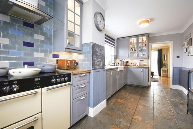 The kitchen is fitted with a range of units, including a wine cooler and a dishwasher.