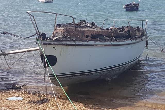 The remaining shell of Matthew's boat which has been destroyed by a fire.