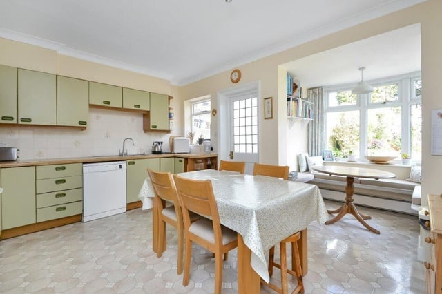 The spacious kitchen area has a fitted window seat and a number of storage cupboards.