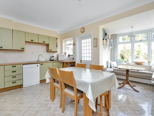 The spacious kitchen area has a fitted window seat and a number of storage cupboards.