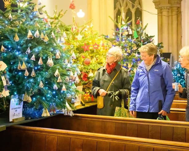 Pictured is: People admiring the decorated trees.
Picture: Keith Woodland (071221-78)
