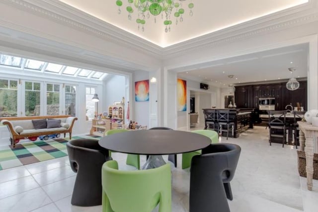 Next to the kitchen is an open plan dining area/conservatory with a roof light and Venetian chandelier above with fully glazed retractable doors to the south of the house.