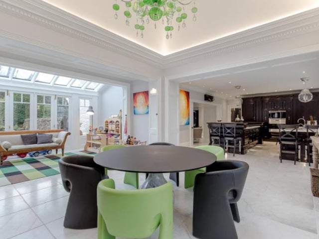 Next to the kitchen is an open plan dining area/conservatory with a roof light and Venetian chandelier above with fully glazed retractable doors to the south of the house.